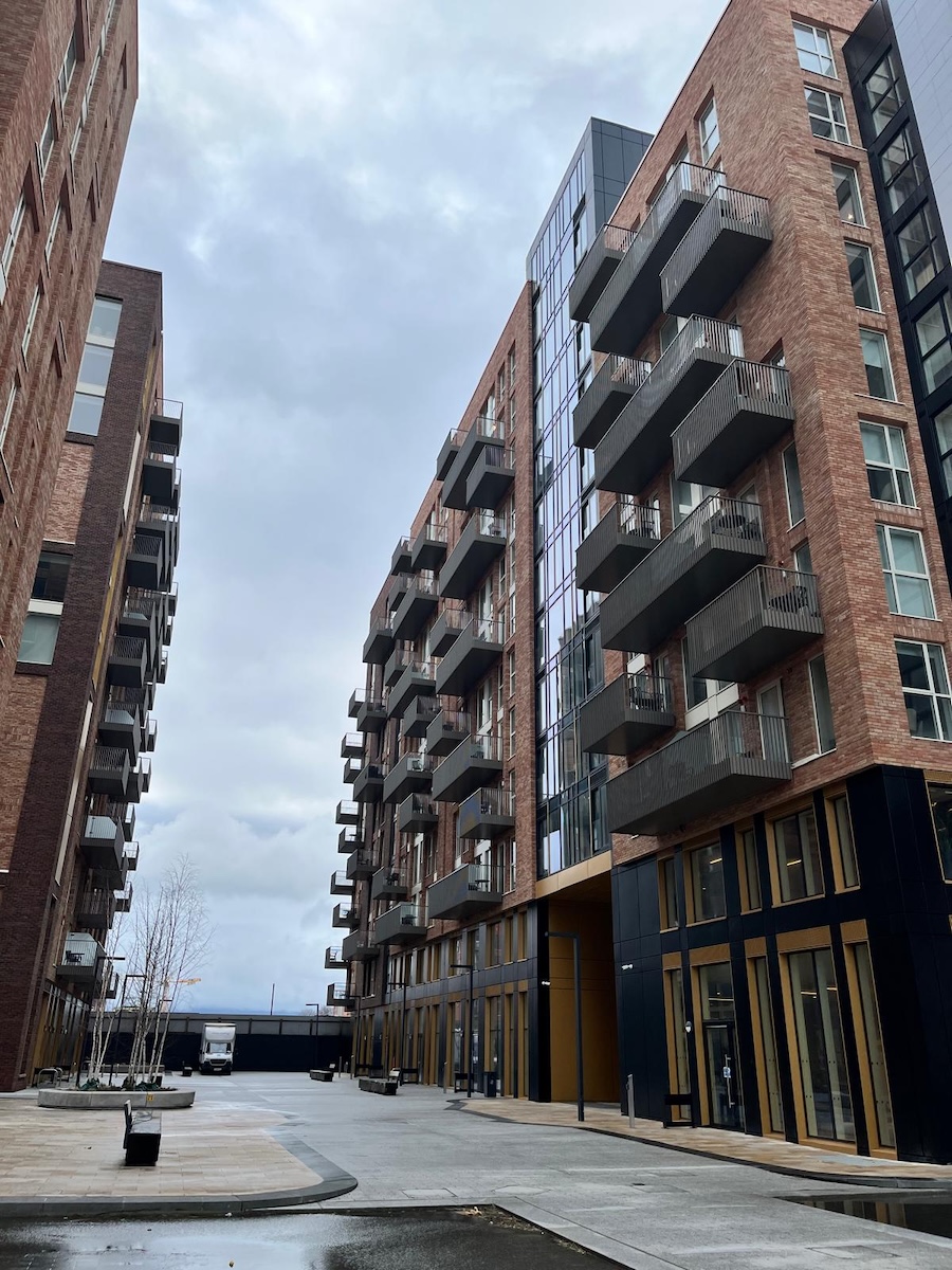 Exterior view of a row of luxury brick apartment buildings with commercial window and door systems designed and installed by NOVUS Windows Ireland.