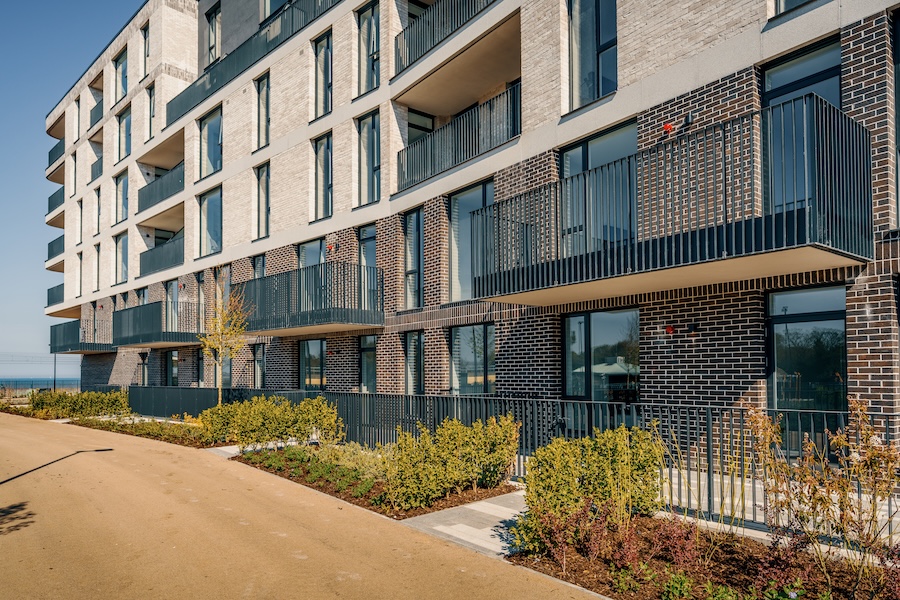 Brightly lit outside view of the Claremont residential development in Howth with a focus on the aluminium windows for apartments and commercial doors Ireland.