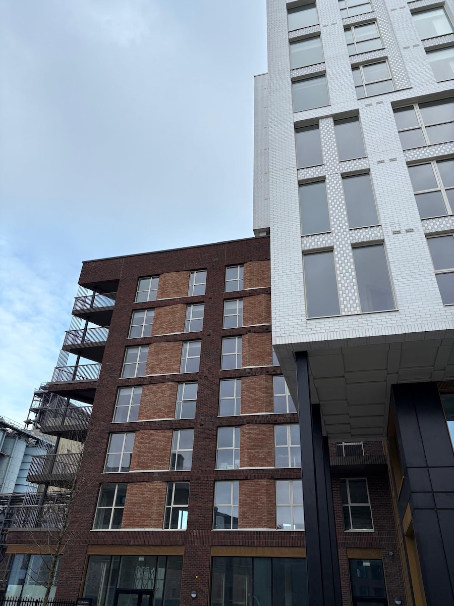 Exterior view of a modern tiered apartment building with commercial window and door systems designed and installed by NOVUS Windows Ireland.
